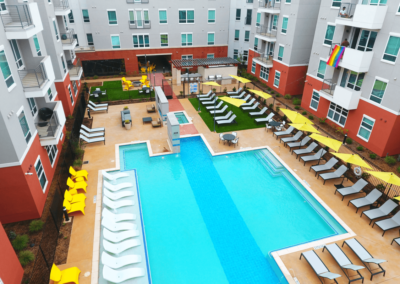 outdoor pool area with lounge chairs at liv+ arlington apartments