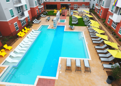 outdoor pool with lounge chairs at liv+ arlington apartments